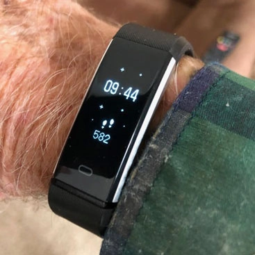 senior wearing a black vitalfit track smartwatch 1