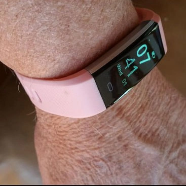 senior wearing a pink vitalfit track smartwatch 3